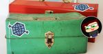 Old green toolbox with the Open Graph protocol logo on the front, and with a red metal toolbox behind it with Open Graph protocol logo on the top of the lid.